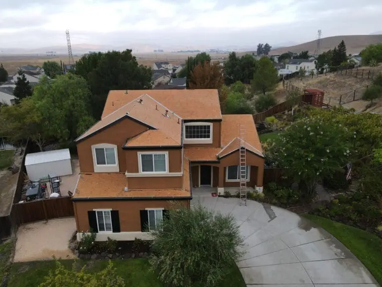 A drone shot of a big brown house