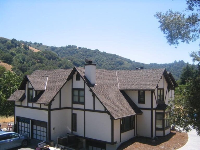 A big house with a chimney exhaust can be seen from a drone shot