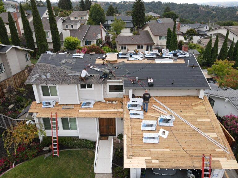 A group of men is conducting a reroofing job