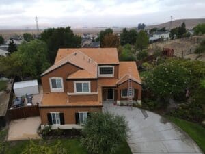 A drone shot of a big brown house