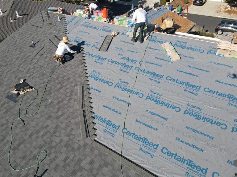 A group of men repairing the roof in progress