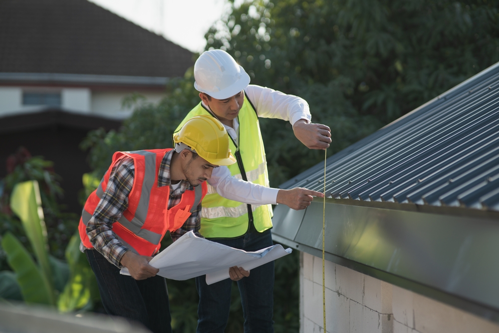 Two roofing experts conducting a roofing inspections