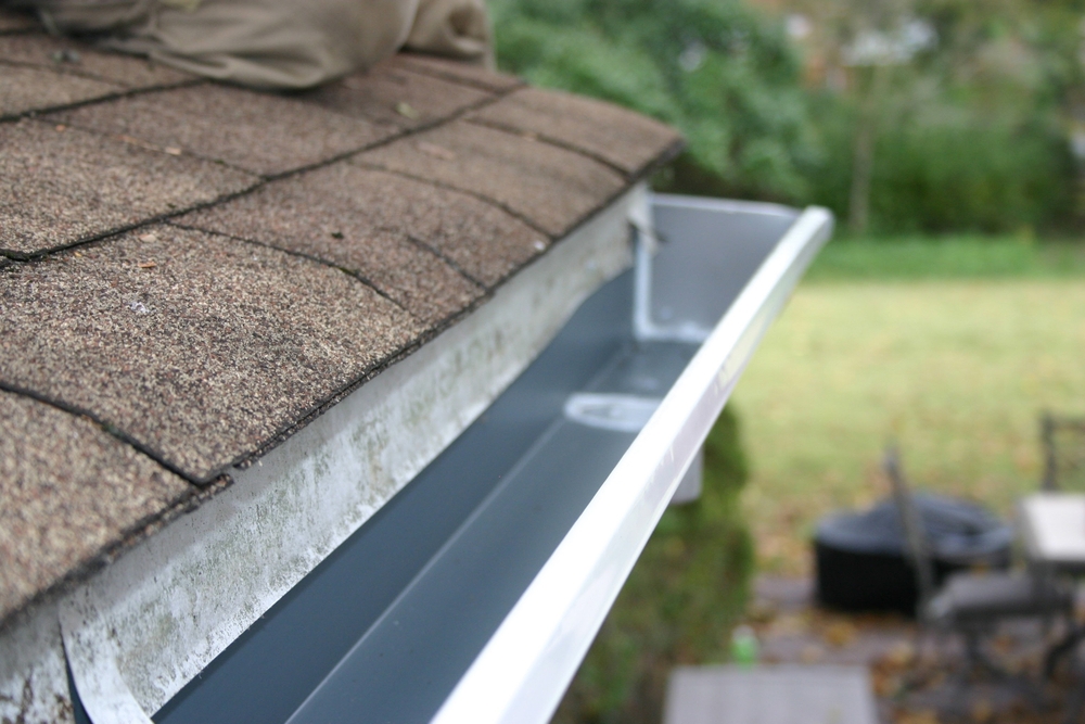 A close up view of a clean and freshly installed house gutter