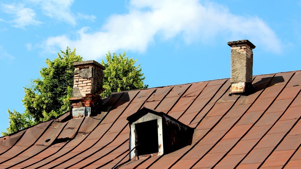 Rusted or lifted roof flashing around vents and chimneys