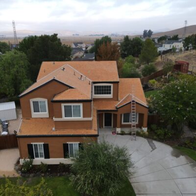 A drone shot of a big brown house